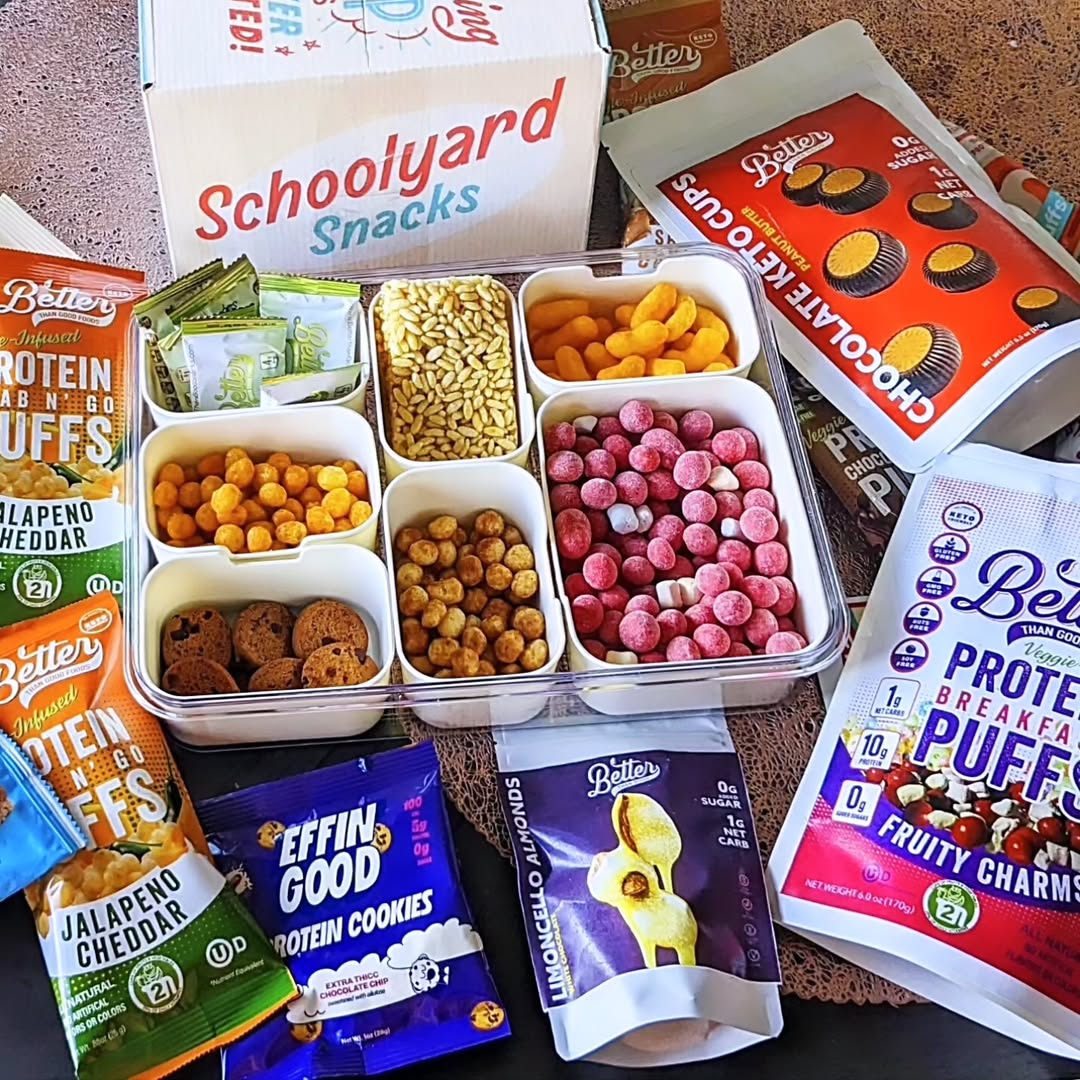 Assorted Schoolyard Snacks and Better Brand protein treats displayed with cereals, puffs, cookies, and chocolate cups.